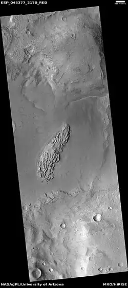Wide view showing light-toned feature that is breaking into blocks, as seen by HiRISE under HiWish program