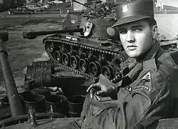 Elvis Presley poses for the camera during his military service at a US base in Germany.