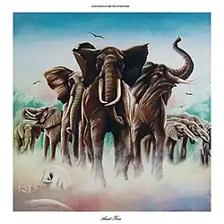 A herd of elephants over a patch of fog. Elvis Costello and the Attractions reads at the top, while Armed Forces reads at the bottom.