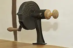 An antique brown and tan marmalade cutter used to cut citrus fruit peel into thin slices.