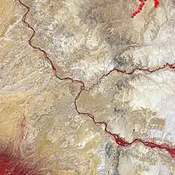 False-color satellite image of the Four Corners. Bright red lines are vegetation along the major rivers of the area. The main southeast–northwest river is the San Juan. The prominent confluence near the center is the confluence with the Mancos River, in New Mexico. The minor confluence northwest of there is with the Toh Dahstini Wash, which drains to the north from Arizona, joining the San Juan in Colorado near the Utah–Colorado border, just north of Four Corners.