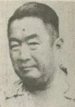 An older Chinese man looking at the camera