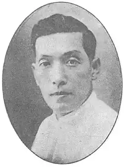 A black-and-white portrait of a man in a white shirt