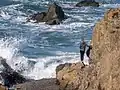 Girl standing on a rock at Glass Beach