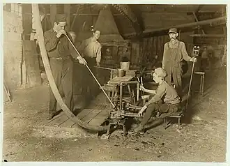 glass factory workers including a glass blower and a mold boy