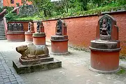 Statues of Nandi (in the foreground), Pande and his two wives, Vishnu, bearded Brahma, Brindi Bhairab and Nandi Bhairab (along the wall from left to right)