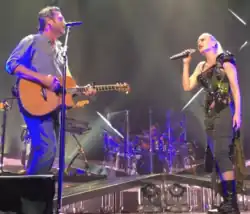 Color picture of singer Gwen Stefani and Blake Shelton performing the aforementioned song live.