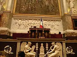 The desk of the president of the National Assembly, designed by Jacques-Louis David, and the tribune of the Chamber, with bas-relief of History and Fame by François-Frédéric Lemot (1797–98)