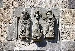 High-relief depiction commemorating the patronage of the Zakaryan brothers (Zakare II Zakarian and Ivane), on the upper east exterior wall of S. Astvatatsin Church, Haghartsin Monastery.
