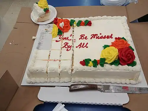 Decorated sheet cake, partially cut for serving