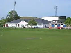 Soccer field with low, pitched-roof building in background
