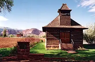 A Utah historic site, this old log schoolhouse with its bell tower and red sandstone steps is a reminder of Torrey's pioneer heritage.