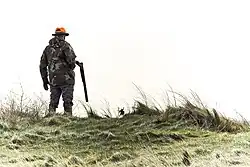 Hunter with long-barreled shotgun