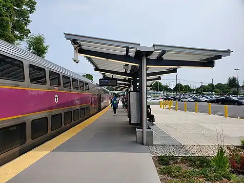 A passenger train next to a curved railway platform