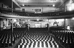Interior of the auditorium facing the stalls, showcasing its blackwood mezzanine, Wunderlich ceiling and wall murals