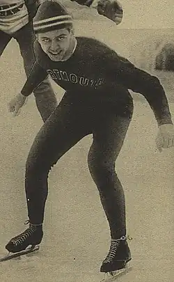 Irving Jaffee wearing a speed-skating outfit on top of ice. The lower half of another athlete can be seen in the background.