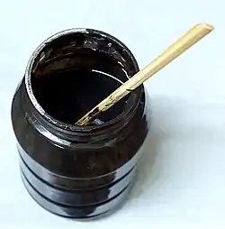 A jar of pitch black paste