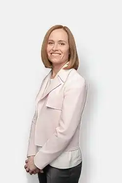 A photograph of Dr. Jeannie Callum with hands clasped, facing the camera