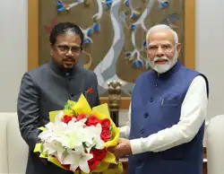 Lieutenant Governor of Puducherry K. Kailashnathan receiving a bouquet of flowers from Prime Minister of India Narendra Modi on August 19, 2024