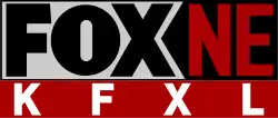 In a gray box with black borders, the Fox network logo in black. To the right, in red on a black area, are the letters N E. Beneath on red are the white letters K F X L.