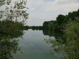 a lake in kaisersee. water in middle, trees to either side.