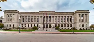 The Kenosha County Courthouse and Jail is a 3-story limestone building in the Neo-Classical style that occupies an entire city block.