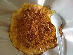 Kerak telor with fried shallots on top.