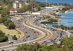 Long shot of a railway line in a freeway median