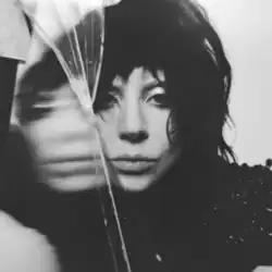 Black-and-white photo of Gaga's face near a piece of glass