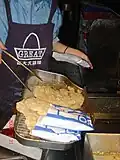 Man selling fried chicken cutlets in Zhongli in March 2006