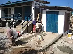 People constructing a ramp for an accessible bathroom