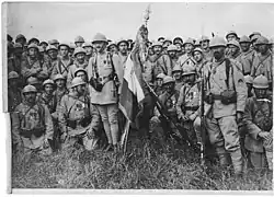 The flag of the Régiment d'infanterie colonial du Maroc, surrounded by marsouins from the unit. Taken on 1 August 1917 at Candor, Oise, France.