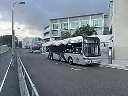 A one-way bus road with two buses parked
