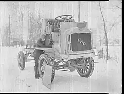 Luella Bates doing mainetance on a FWD Model B truck.