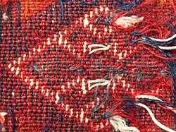 Detail of reverse showing ragged ends of weft threads of different colours