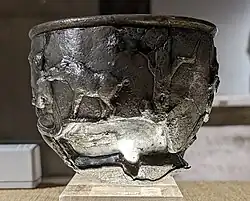 A boar and a tree (perhaps with mistletoe).