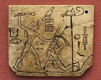 Tag depicting king Den; c.&nbsp;3000&nbsp;BC; ivory; 4.5 × 5.3&nbsp;cm; from Abydos (Egypt); British Museum (London)[21]