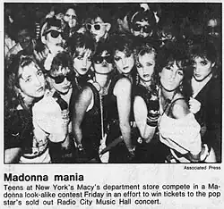 A group of girls dress as Madonna, caption reads "Madonna mania: Teens at New York's Macy's department store compete in a Madonna look-alike contest Friday in an effort to win tickets to the pop star's sold out Radio City Music Hall concert."