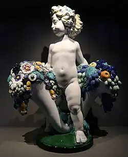Austrian Art Nouveau&nbsp;– Putto with two cornucopias with floral cascades, by Michael Powolny, designed in c. 1907, produced in 1912, ceramic, Kunstgewerbemuseum Berlin, Berlin, Germany[68]