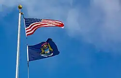 The Michigan flag flying under the U.S. flag