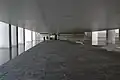 The open-floored ground level beneath the suspended offices