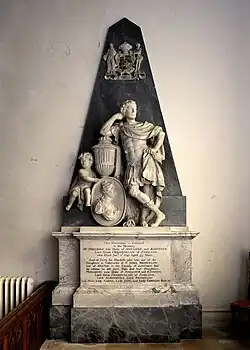 This image shows the monument to the 2nd Duke of Ancaster at Edenham, Lincolnshire, exemplifying the Georgian fashion for depicting prominent English figures in classical Roman attire. The monument features a distinctive pyramid backdrop, a popular eighteenth-century design element that became ubiquitous in Georgian commemorative art. The Duke is portrayed as a Roman military commander in classical dress, striking a heroic pose with one hand resting on a decorative urn whilst accompanied by allegorical figures including cherubs. This classical treatment reflects the prevailing sentiment that England, with its parliamentary limitations on monarchical power, paralleled Republican Rome. The monument combines white marble sculpture against a dark pyramid background, topped with the ducal coat of arms. At the base is a detailed inscription panel set within a marble framework. Such monuments demonstrate how eighteenth-century sculptors used classical imagery and pyramidal compositions to create grand theatrical scenes that celebrated both the deceased's earthly achievements and their anticipated heavenly status.
