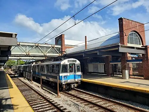 A rapid transit train at a surface-level station