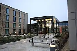 A photo of the outside of the David Kato college hub on an overcast February day at sunset.