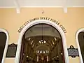 Church main door showing the nave. The inscription above it reads Hæc est Domus Dei et Porta Cœli ("Here is the House of God and the Door to Heaven").