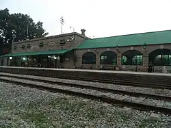Stone railway station with a green roof