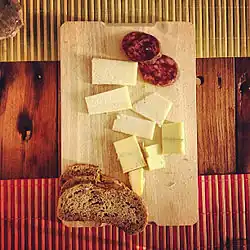 Brown bread served with cheese and sausage