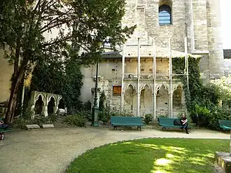 Flamboyant Gothic arches of the Chapel of the Virgin (13th c.) displayed in the Square next to the church
