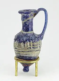 Perfume vase in shape of an amphoriskos; 664–630&nbsp;BC; glass: 8&nbsp;cm ×&nbsp;4&nbsp;cm (3.1&nbsp;in ×&nbsp;1.6&nbsp;in); Metropolitan Museum of Art