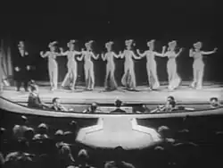 Nicky performs "Red Hot and Beautiful" at the burlesque Gaiety Theatre.